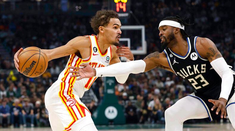 Atlanta Hawks guard Trae Young (11) drives against Milwaukee Bucks' Wesley Matthews (23) during the first half of an NBA basketball game, Saturday, Oct. 29, 2022, in Milwaukee. (AP Photo/Jeffrey Phelps)