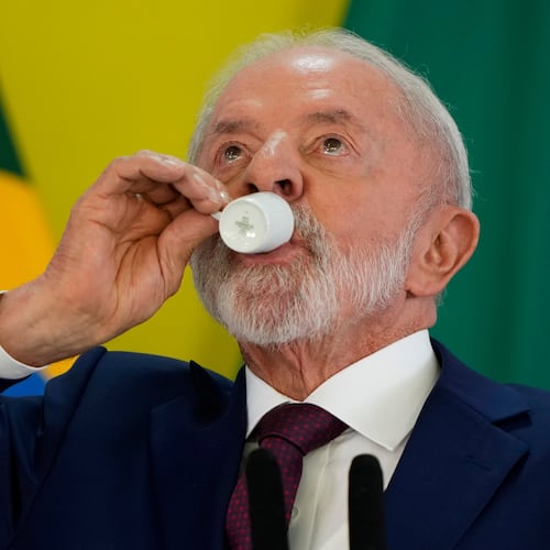 Brazilian President Luiz Inacio Lula da Silva takes a sip of coffee during a year-end press conference at Planalto presidential palace in Brasilia, Brazil, Thursday, Dec. 18, 2025. (AP Photo/Eraldo Peres)
