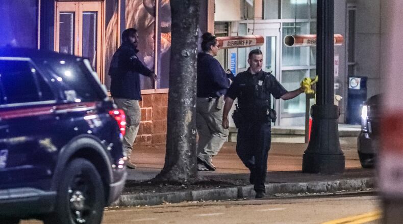 October 26, 2021 Atlanta: The GBI and Atlanta police worked the scene on Tuesday, Oct. 26, 2021 after a  Molena police officer working an off-duty job in parking enforcement was shot Monday night as he was sitting in his vehicle in downtown Atlanta, officials said. The officer was working for ATL Plus when he was approached by the alleged gunman on Luckie Street shortly before 10 p.m., according to the GBI. The state agency said the officer took a bullet to the neck and returned fire, fatally wounding the man. The officer’s injuries were not considered life-threatening, GBI spokeswoman Nelly Miles said in a news release. “Agents on scene found the man who died in possession of a firearm,” she said. The names of the two men were not released. A third gunshot victim, a woman, was also found at the scene, according to Atlanta police. She was taken to a hospital with what police believed to be a graze wound. “The preliminary investigation indicates there may have been some type of altercation between the two males that escalated to gunfire,” an Atlanta police spokesman said in a statement. According to Channel 2 Action News, the officer argued with the man about a parking ticket before shots were fired. Officials have not confirmed the motive. Molena is a town of fewer than 500 in southwest Pike County, more than 60 miles south of downtown Atlanta. The injured officer serves in a reserve capacity, according to the GBI. The GBI is investigating the incident as an officer-involved shooting, the 80th such shooting this year. The Atlanta Journal-Constitution also tracks officer-involved shootings that don’t involve the GBI, and those numbers sometimes differ from the GBI’s tally. (John Spink / John.Spink@ajc.com)