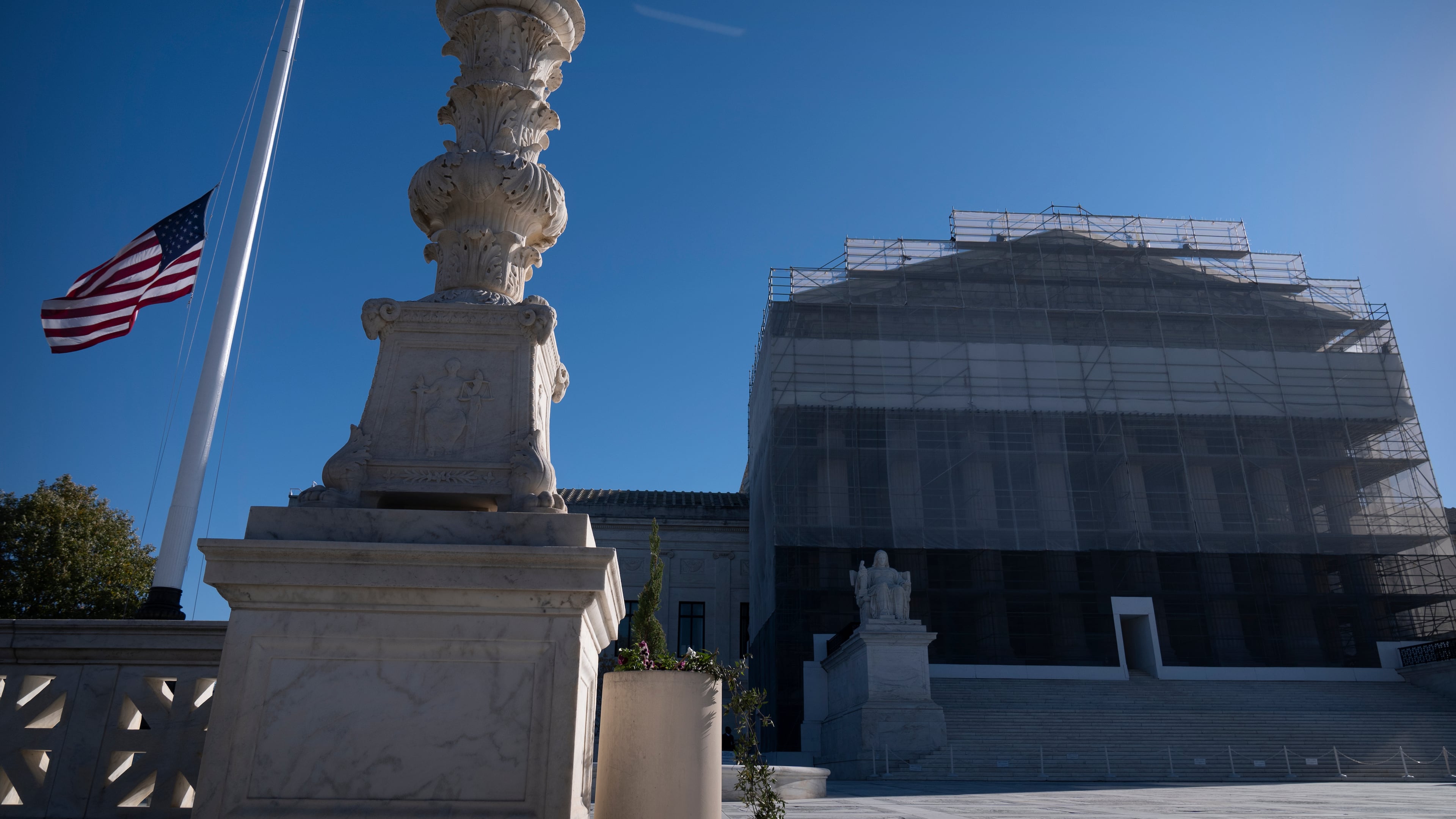An American flag flies at half-staff outside the Supreme Court on Wednesday, Nov. 5, 2025, in Washington. (AP Photo/Mark Schiefelbein)