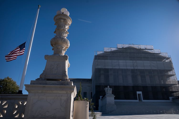 An American flag flies at half-staff outside the Supreme Court on Wednesday, Nov. 5, 2025, in Washington. (AP Photo/Mark Schiefelbein)