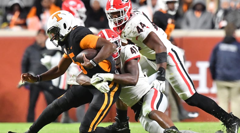 November 13, 2021 Knoxville, TN - Tennessee's quarterback Hendon Hooker (5) is sacked by Georgia's linebacker Channing Tindall (41) in the second half during a NCAA football game at Neyland Stadium in Knoxville on Saturday, November 13, 2021. Georgia won 41-17 over Tennessee. (Hyosub Shin / Hyosub.Shin@ajc.com)