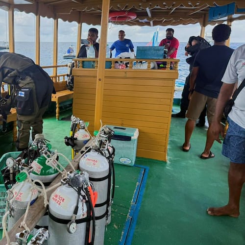 In this handout photo release by Maldives President Media Division, a Finnish diver, left, gets ready to attempt to recover the bodies of two of the four Italians who died deep inside an underwater cave in an atoll earlier this month, at Alimathaa Island, in Vaavu Atoll, Maldives, Tuesday, May 19, 2026. (Maldives President Media Division via AP)