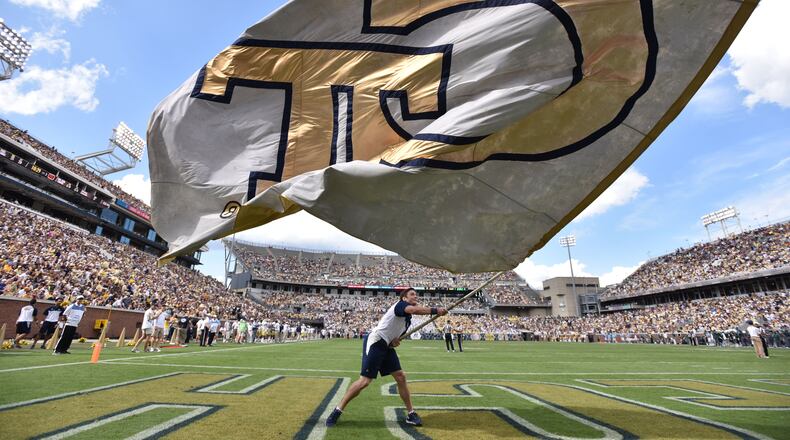 September 12, 2015 Atlanta - Georgia Tech cheerleader team member waves a giant Georgia Tech flag in the first half against the Tulane Green Wave at Bobby Dodd Stadium on Saturday, September 12, 2015. HYOSUB SHIN / HSHIN@AJC.COM