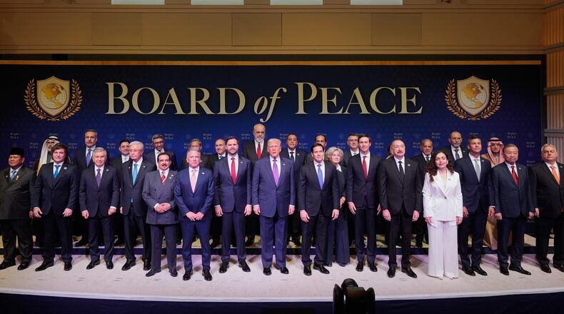 FILE - President Donald Trump stands with other World leaders before a Board of Peace meeting at the U.S. Institute of Peace, Feb. 19, 2026, in Washington. (AP Photo/Mark Schiefelbein, File)