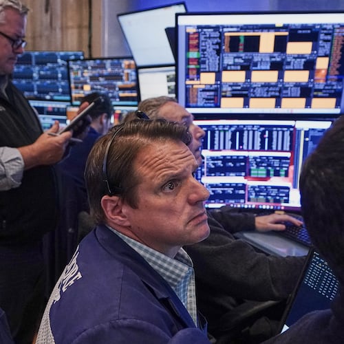 Trader Michael Milano, center, works on the floor of the New York Stock Exchange, Friday, June 26, 2026. (AP Photo/Richard Drew)
