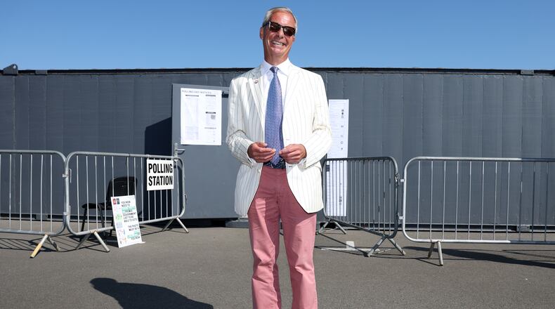 Britain's Reform UK party leader Nigel Farage arrives at a polling station in Walton on the Naze, Thursday, Aug. 13, 2026 to cast his vote for the Clacton on Sea by-election.(AP Photo/Richard Pelham)