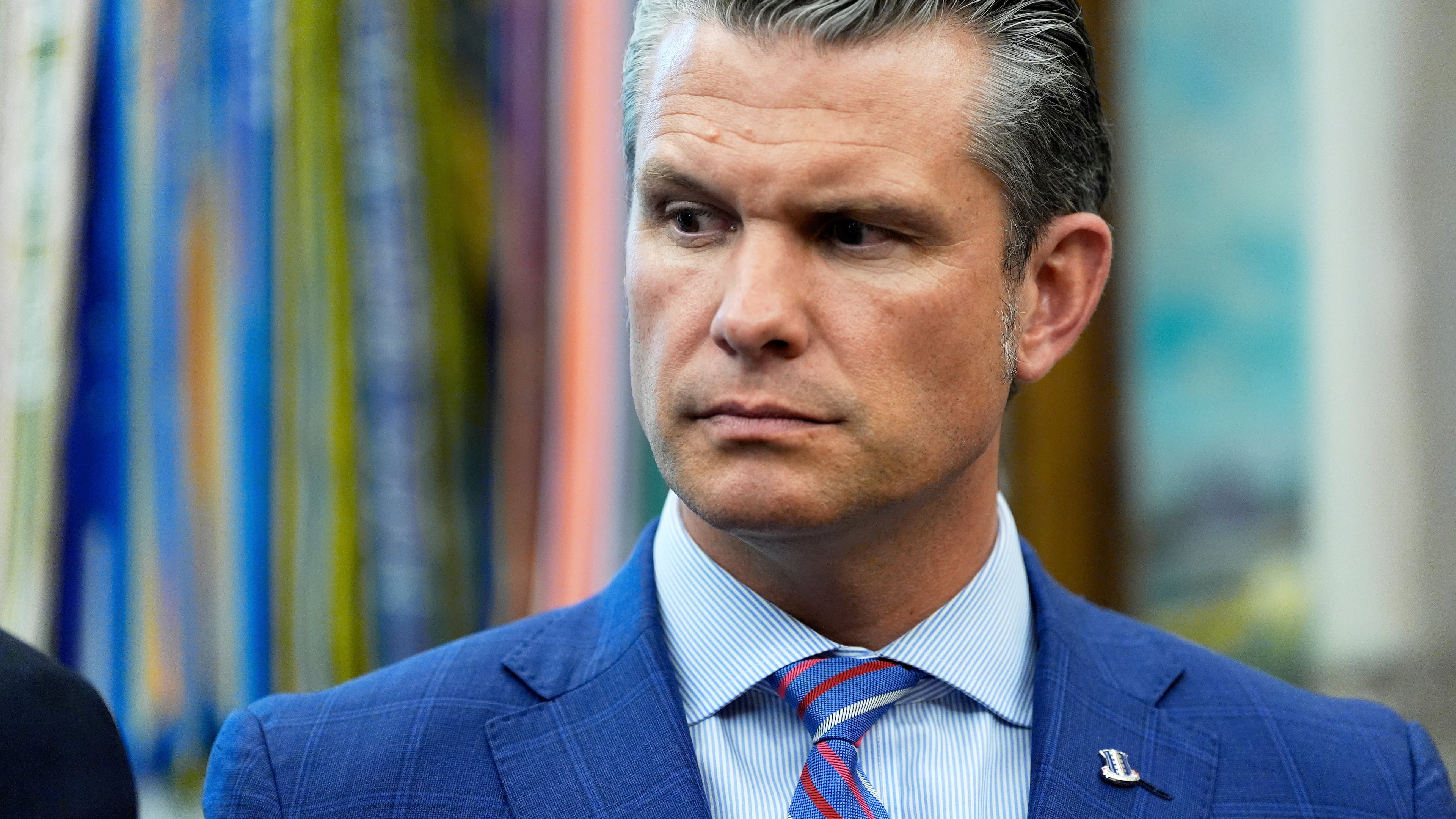 Defense Secretary Pete Hegseth listens as President Donald Trump speaks in the Oval Office of the White House, Monday, Sept. 15, 2025, in Washington. (AP Photo/Alex Brandon)