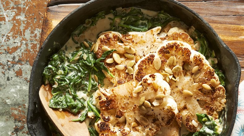 Skillet-Roasted Cauliflower Steaks With Jalapeno Creamed Spinach from “Better Homes and Gardens Skillet Meals (Better Homes & Gardens, $24.99). Credit: Meredith Corporation