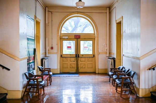 A first floor hallway of the historic building at 208 Bull St. in Savannah, Ga., leading to an exit to Oglethorpe Avenue. (Sarah Peacock for The Atlanta Journal-Constitution) 