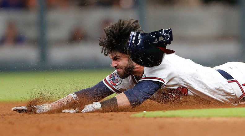 Atlanta Braves' Dansby Swanson (7) dives in to second base with a double in the ninth inning of a baseball game against the New York Mets Friday, June 9, 2017, in Atlanta. Swanson scored the winning run later in the inning to give Atlanta 3-2 victory. (AP Photo/John Bazemore)