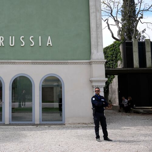 FILE - A private security officer stands next to a closed Russia's pavilion at the 59th Biennale of Arts exhibition in Venice, Italy, Tuesday, April 19, 2022. (AP Photo/Antonio Calanni, File)