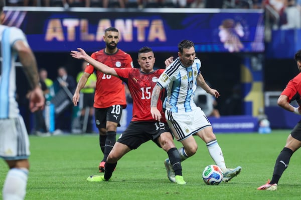 Argentina's Lionel Messi (right) wins the battle for the ball with Egypt's Karim Hafez during the first half of the Argentina vs. Egypt FIFA World Cup match at Atlanta Stadium (Mercedes-Benz Stadium) on Tuesday, July 7, 2026. (Jason Getz/AJC)