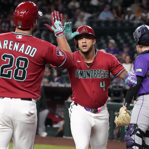 Arizona Diamondbacks' Ketel Marte celebrates with Nolan Arenado (28) after hitting a solo home run against the Colorado Rockies in the first inning of a baseball game, Tuesday, Aug. 11, 2026, in Phoenix. (AP Photo/Rick Scuteri)