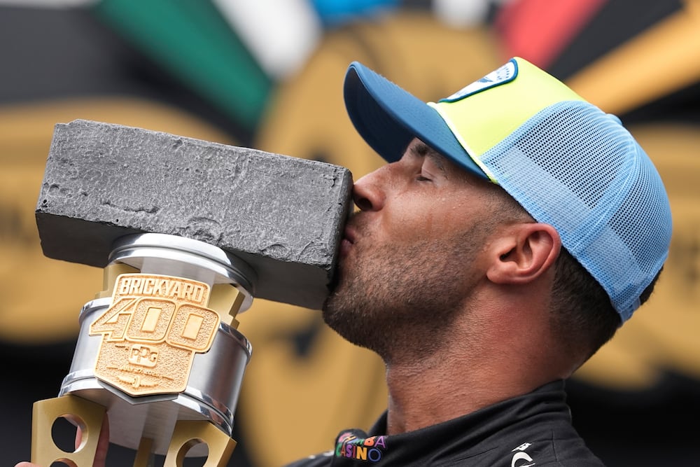 Bubba Wallace kisses the trophy after winning a NASCAR Cup Series auto race at Indianapolis Motor Speedway on Sunday, July 27.