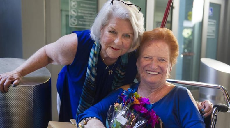 Toni Rosenberg, right, of Boca Raton, Florida, meets her sister Florence Serino, of Irvine, California, for the first time this week at Fort Lauderdale-Hollywood International Airport on Tues. Rosenberg was adopted as a newborn a mysterious, closed adoption and had never met any of her biological family members until now.