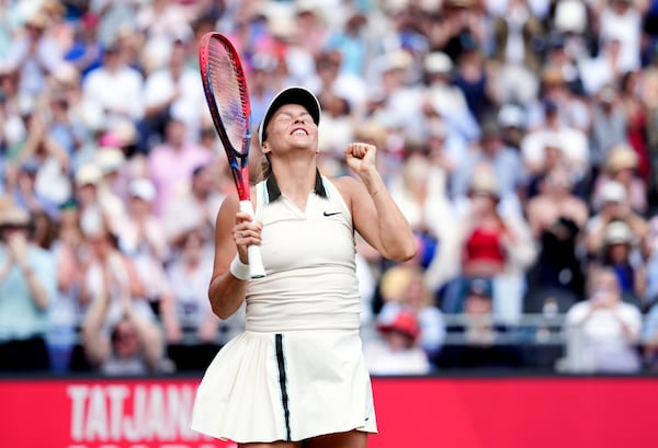 Germany's Tatjana Maria celebrates following her semifinal match against Madison Keys of the U.S. on day six of the HSBC Championships at The Queen's Club, London, Saturday June 14, 2025. (John Walton/PA via AP)