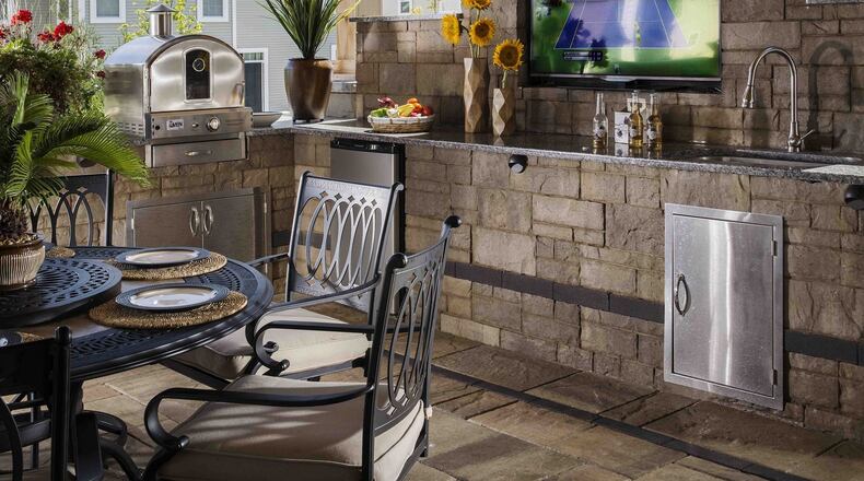 A high-tech outdoor kitchen and TV transform a basic outdoor patio. Contributed by Belgard