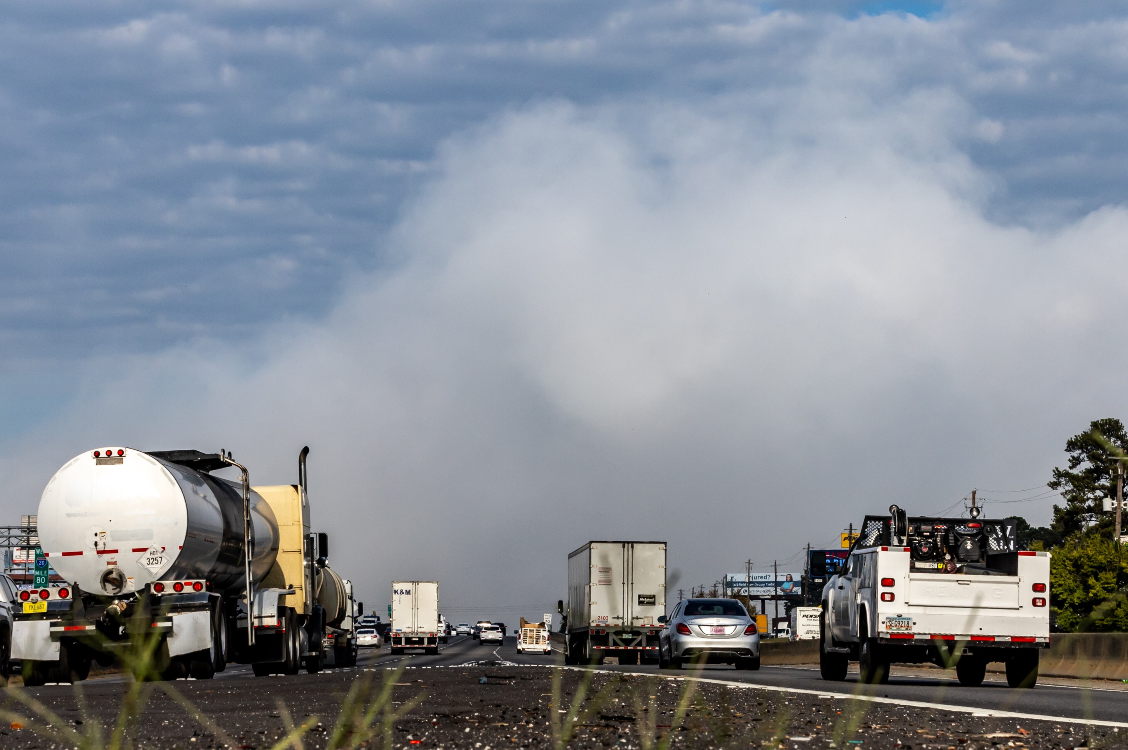 Westbound traffic on I-20 approach the plume of smoke rising from BioLab that continued on Thursday, Oct. 3, 2024 in Conyers. A Sunday fire at the chemical plant in Conyers has had agencies monitoring the air quality since then as crews try to neutralize the site. Rockdale County officials said that the plume is changing colors as workers remove debris. GEMA has advised anyone who notices a chlorine odor in the air to limit their time outdoors. (John Spink/AJC)