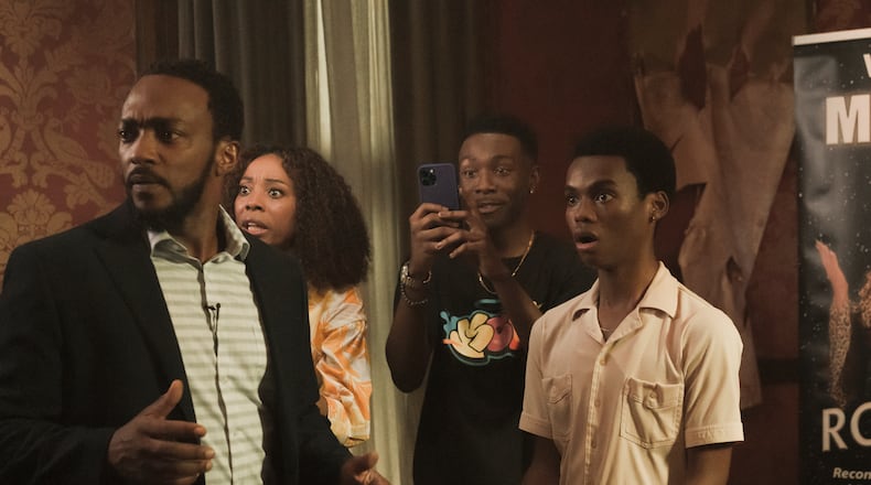 We Have A Ghost stars (L to R) Anthony Mackie as Frank, Erica Ash as Melanie, Niles Fitch as Fulton, and Jahi Winston as Kevin. / Cr. Scott Saltzman/Netflix © 2022.