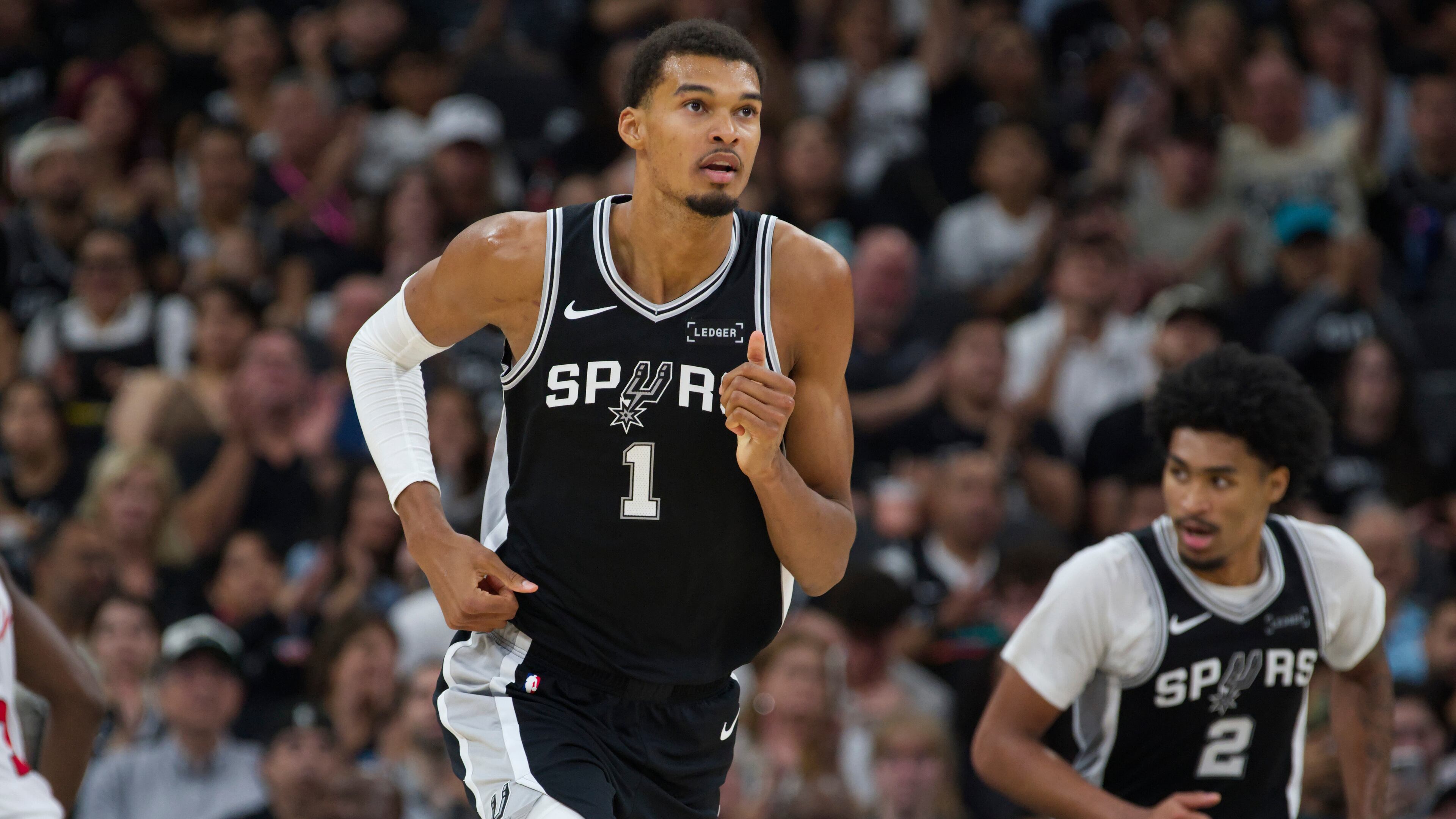 San Antonio Spurs center Victor Wembanyama (1) runs up-court during the second half of an NBA basketball game against the Toronto Raptors, Monday, Oct. 27, 2025, in San Antonio. (AP Photo/Darren Abate)