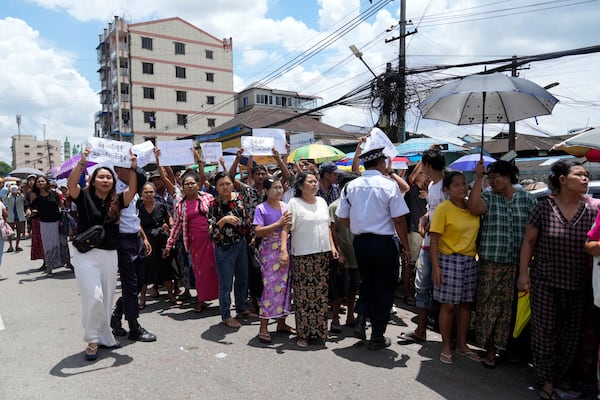 Family members and colleagues wait to welcome released prisoners outside the main gate of Insein prison as the head of Myanmar’s military government granted amnesty to thousands of prisoners to mark the country's traditional New Year Thursday, April 17, 2025, in Yangon, Myanmar. (AP Photo/Thein Zaw)