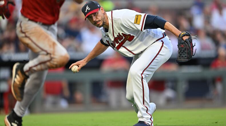 Braves starting pitcher Charlie Morton (50) throws to first base after fielding the grounder by Arizona Diamondbacks' right fielder Jake McCarthy (foreground) during the fifth inning at Truist Park, Wednesday, July 19, 2023, in Atlanta. The Diamondbacks won 5-3 over the Braves. (Hyosub Shin / Hyosub.Shin@ajc.com)