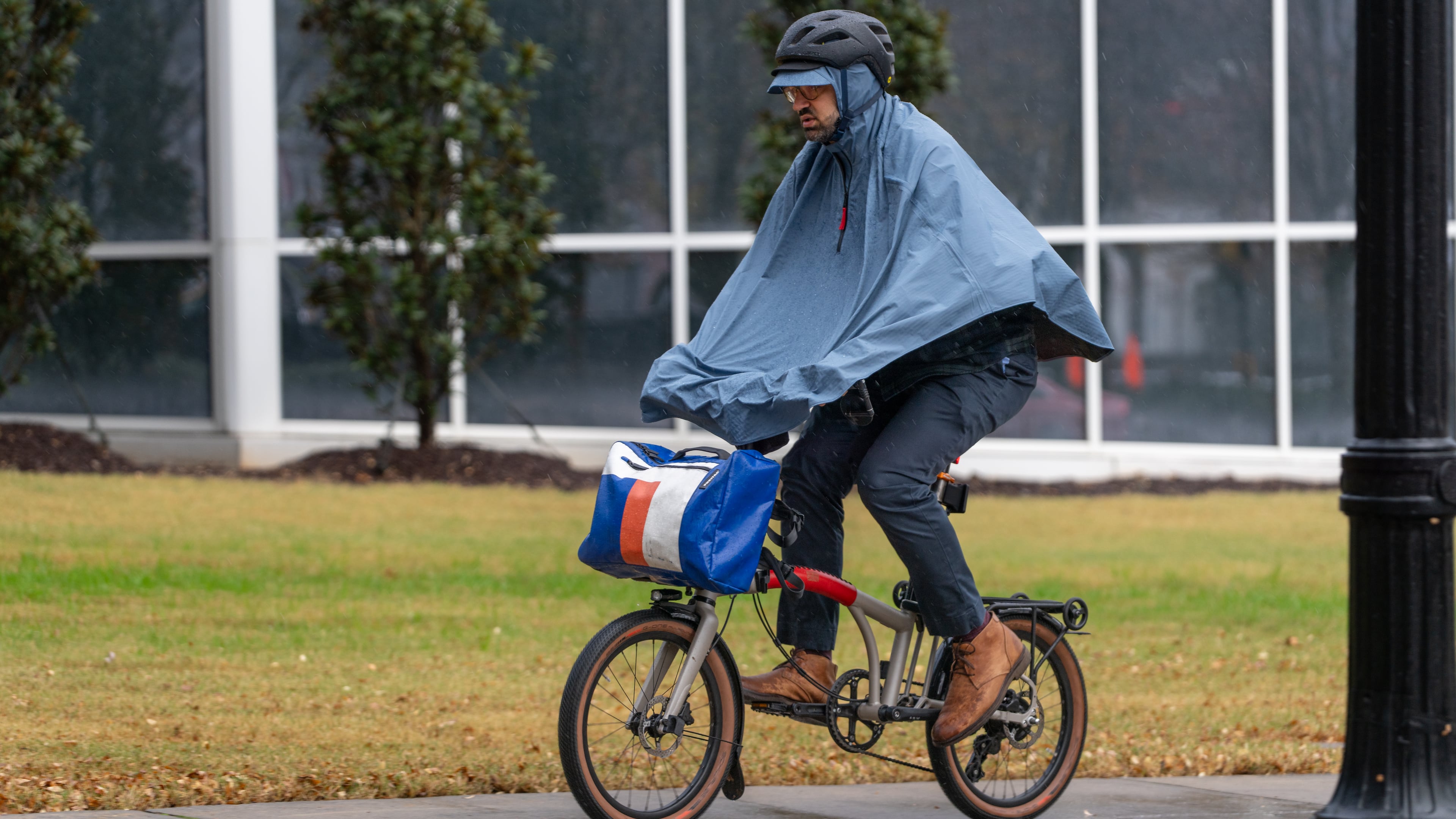 A man rides a bicycle in the rain along 10th Street in downtown Atlanta on Tuesday, Nov. 25, 2025. (Ben Hendren for the AJC)