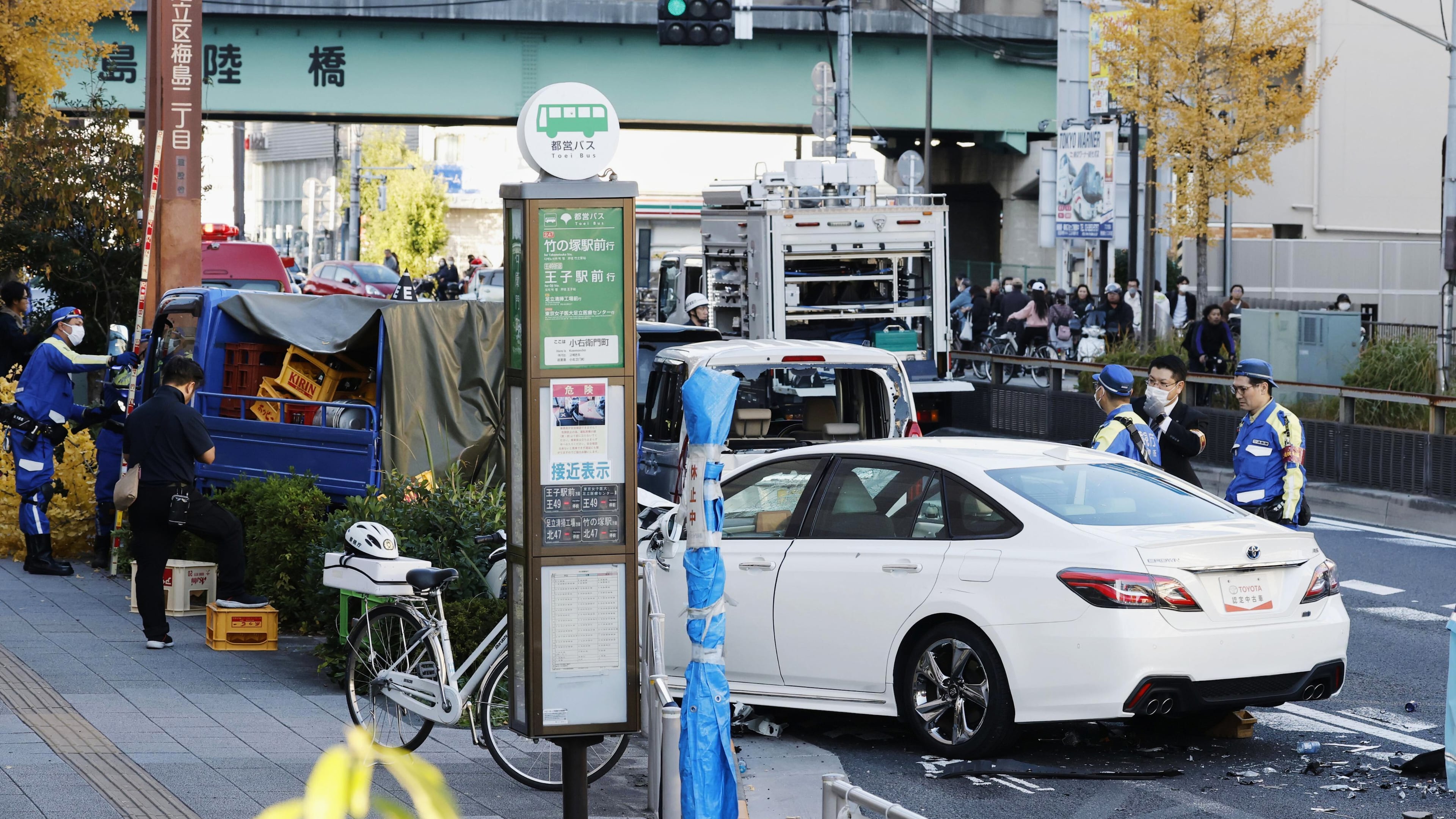 Investigators inspect the scene of a car accident injuring multiple people in Tokyo, Monday, Nov. 24, 2025. (Michi Ono/Kyodo News via AP)