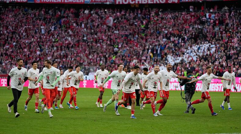 Bayern players celebrate after their team clinched the German league title after a Bundesliga soccer match between Bayern and Stuttgart in Munich, Germany, Sunday, April 19, 2026. (AP Photo/Matthias Schrader)