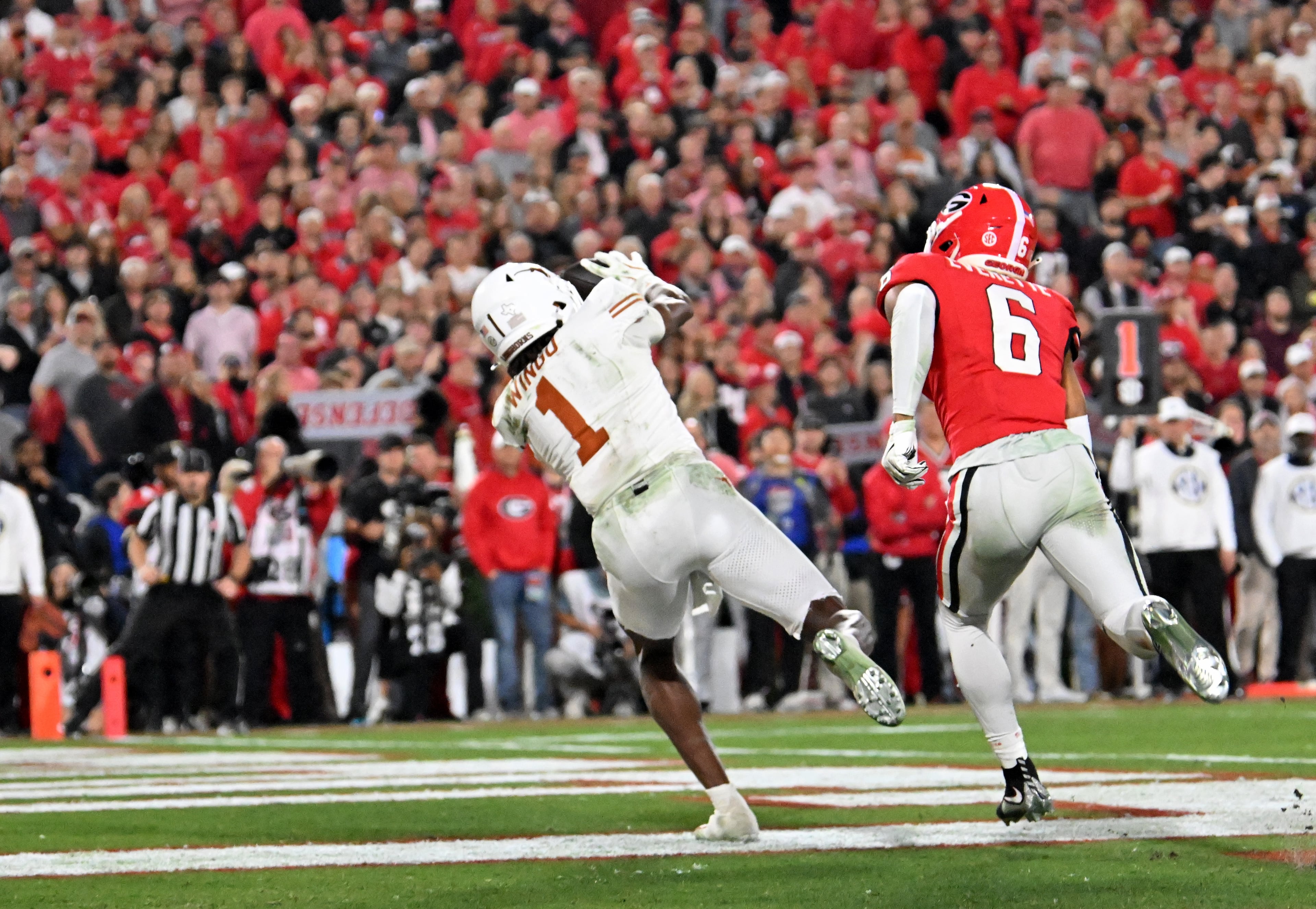 Texas wide receiver Ryan Wingo (1) makes a touchdown pass past Georgia defensive back Daylen Everette (6) during the second half in an NCAA football game at Sanford Stadium, Saturday, November 15, 2025, in Athens. Georgia won 35-10 over Texas. (Hyosub Shin / AJC)