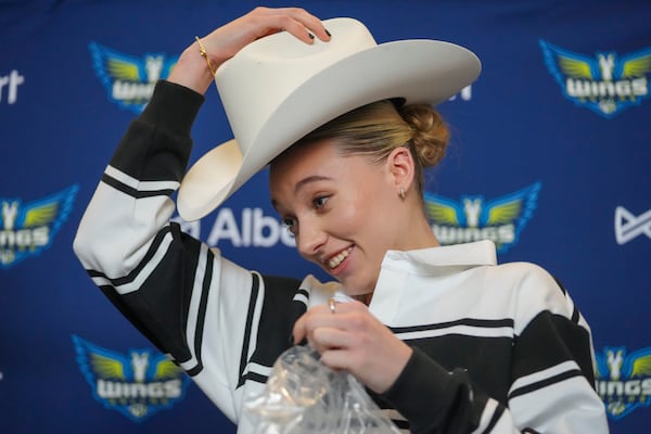 Dallas Wings' Paige Bueckers, selected No. 1 overall in the WNBA basketball draft, sports a cowboy hat gifted to her during an introductory press conference Wednesday, April 23, 2025, in Dallas. (AP Photo/Julio Cortez)