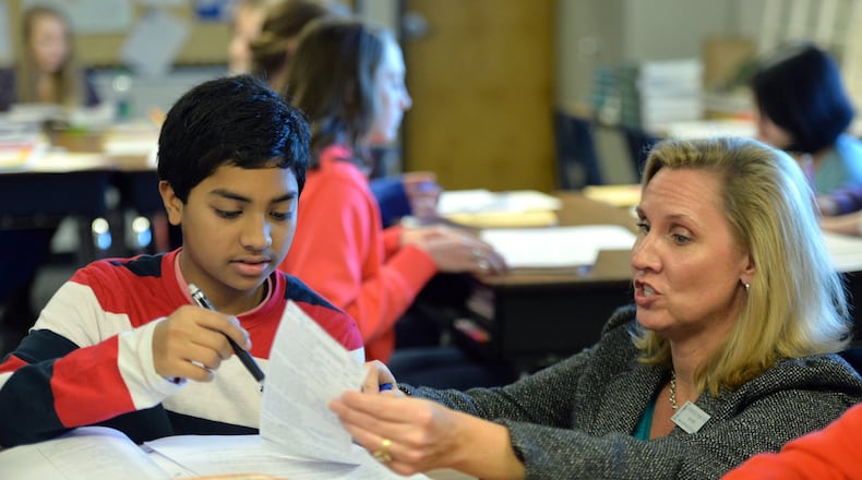 December 11, 2014 Buford - Kimberly Hartter instructs her student Akash Sinha during her 8th Grade Language Arts class at Twin Rivers Middle School in Buford.