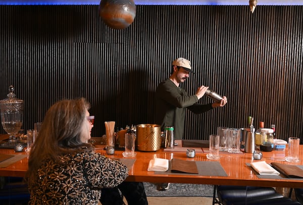 Trenton Austin, general manager at 7th House, makes Rolene Jaffe her favorite nonalcoholic drink. Each drink at the Atlanta restaurant is aligned to a zodiac sign, its ingredients chosen to reflect the personality of that sign. (Hyosub Shin/AJC)