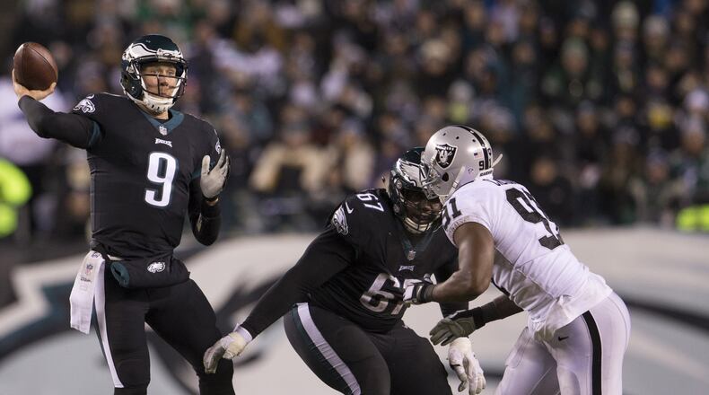 PHILADELPHIA, PA - DECEMBER 25: Nick Foles #9 of the Philadelphia Eagles passes the ball as Chance Warmack #67 blocks Shilique Calhoun #91 of the Oakland Raiders in the second quarter at Lincoln Financial Field on December 25, 2017 in Philadelphia, Pennsylvania. (Photo by Mitchell Leff/Getty Images)