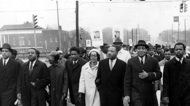 Rev. Martin Luther King Jr., Coretta Scott King, Ralph David Abernathy, John Lewis and others march from Atlanta University to the Georgia State Capitol in 1966. AJC file photo
