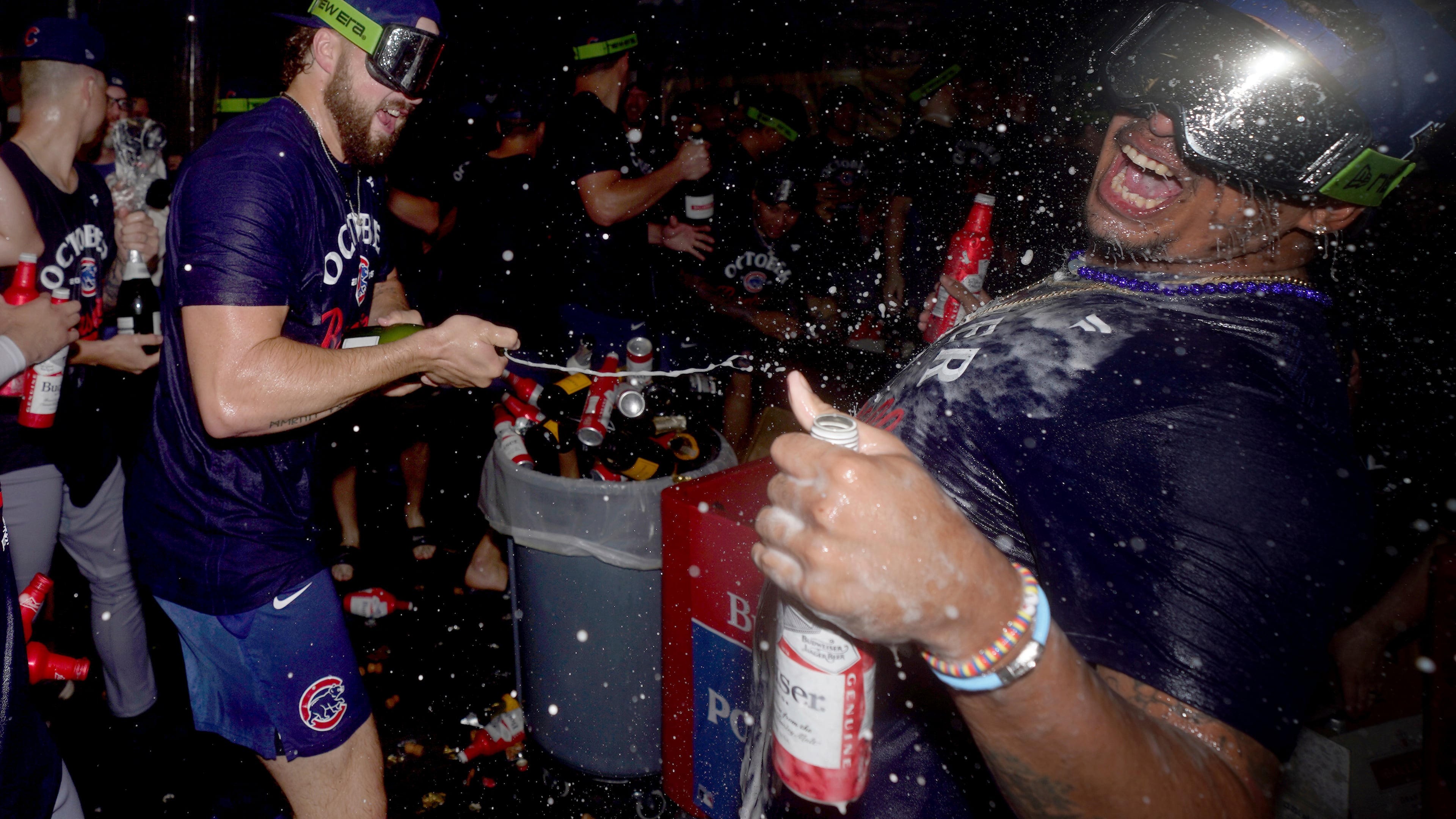 Chicago Cubs' Porter Hodge, left, celebrates with Daniel Palencia, right, in the clubhouse after the Cubs clinched a playoff berth after defeating the Pittsburgh Pirates in a baseball game Wednesday, Sept. 17, 2025, in Pittsburgh. (AP Photo/Matt Freed)