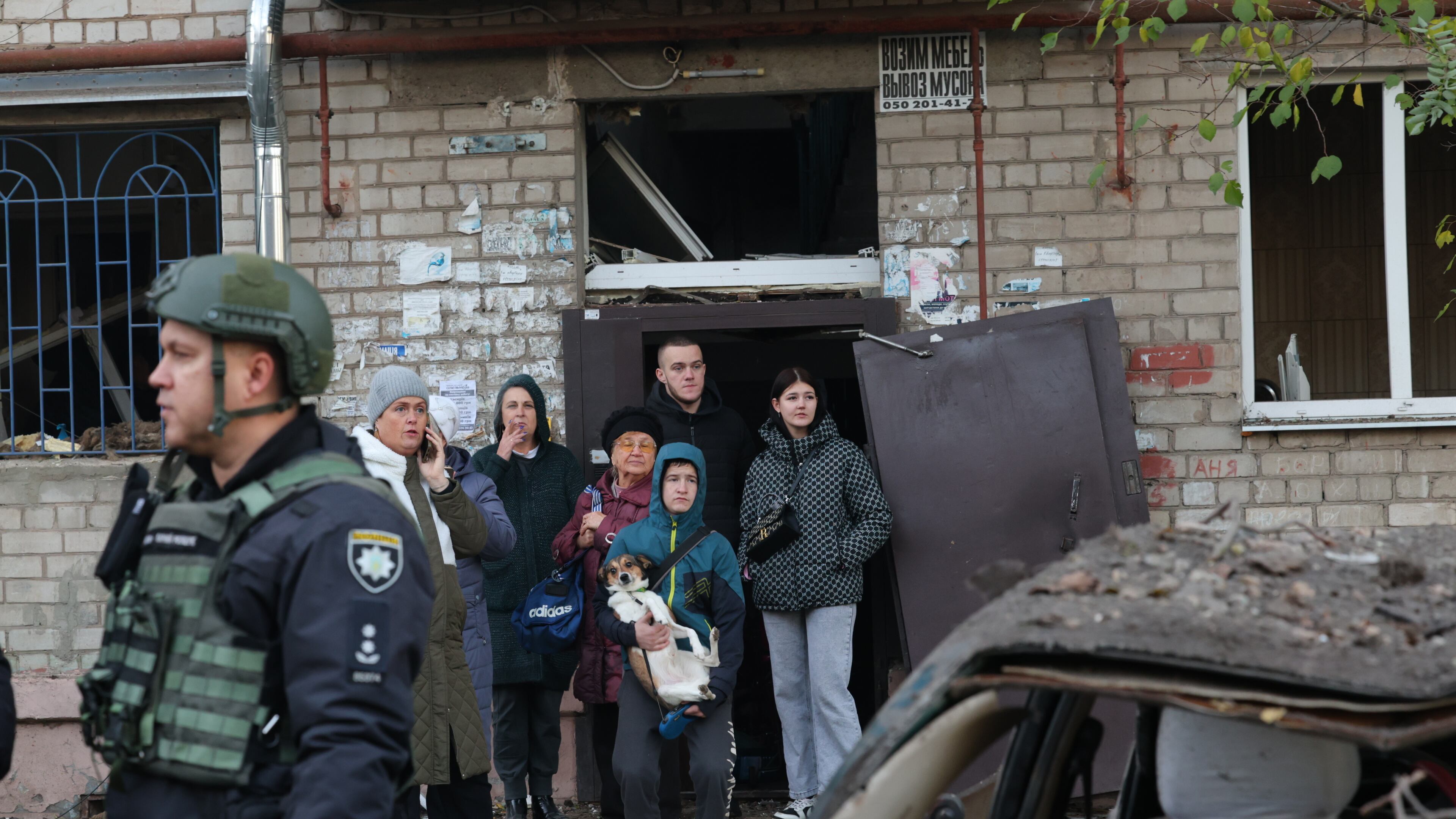 Local residents react after a Russian missile hit their hostel in Zaporizhzhia, Ukraine, Thursday, Oct. 30, 2025. (AP Photo/Kateryna Klochko)