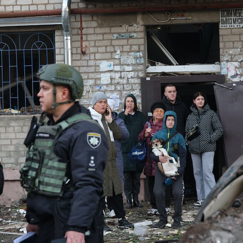 Local residents react after a Russian missile hit their hostel in Zaporizhzhia, Ukraine, Thursday, Oct. 30, 2025. (AP Photo/Kateryna Klochko)