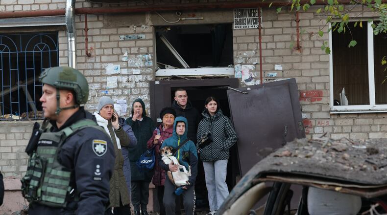 Local residents react after a Russian missile hit their hostel in Zaporizhzhia, Ukraine, Thursday, Oct. 30, 2025. (AP Photo/Kateryna Klochko)