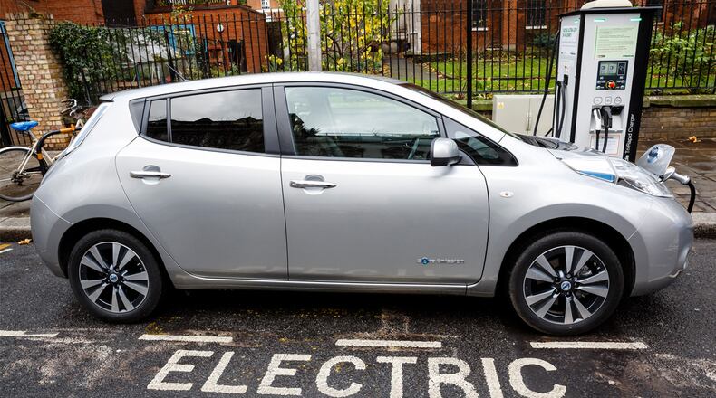 Go Ultra Low Nissan LEAF on charge on a London street. Ultra-low emission vehicles such as this can cost as little as 2p per mile to run and some electric cars and vans have a range of up to 700 miles. ( Miles Willis/Stringer/Getty Images)