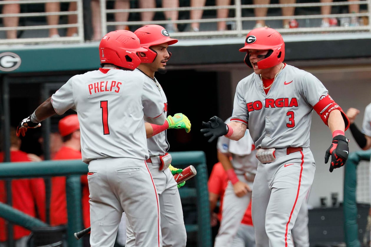 Georgia Bulldogs catcher Daniel Jackson is greeted by infielder Tre Phelps at home plate after hitting a two-run homer to give the team the lead in Game 2 of the NCAA Super Regional on June 7, 2026. (Miguel Martinez/AJC)