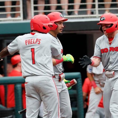 Georgia Bulldogs catcher Daniel Jackson is greeted by infielder Tre Phelps at home plate after hitting a two-run homer to give the team the lead in Game 2 of the NCAA Super Regional on June 7, 2026. (Miguel Martinez/AJC)