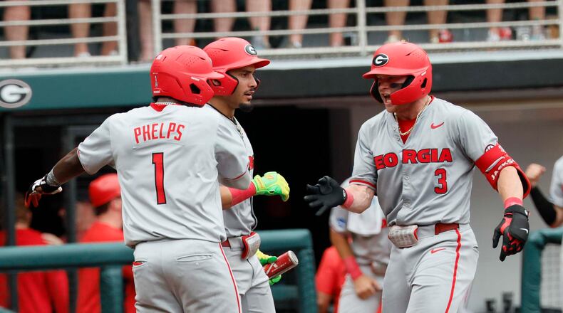 Georgia Bulldogs catcher Daniel Jackson is greeted by infielder Tre Phelps at home plate after hitting a two-run homer to give the team the lead in Game 2 of the NCAA Super Regional on June 7, 2026. (Miguel Martinez/AJC)