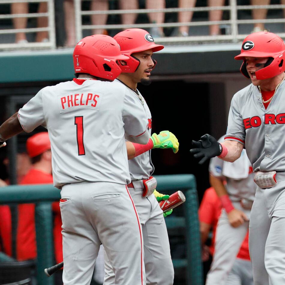 Georgia Bulldogs catcher Daniel Jackson is greeted by infielder Tre Phelps at home plate after hitting a two-run homer to give the team the lead in Game 2 of the NCAA Super Regional on June 7, 2026. (Miguel Martinez/AJC)