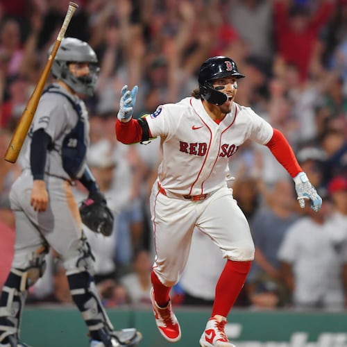 Boston Red Sox's Jarren Duran, right, celebrates in front of New York Yankees catcher Austin Wells, left, after hitting a walk-off one-run single in the tenth inning of a baseball game, Sunday, June 28, 2026, in Boston. (AP Photo/Steven Senne)