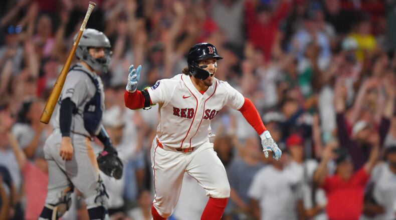 Boston Red Sox's Jarren Duran, right, celebrates in front of New York Yankees catcher Austin Wells, left, after hitting a walk-off one-run single in the tenth inning of a baseball game, Sunday, June 28, 2026, in Boston. (AP Photo/Steven Senne)