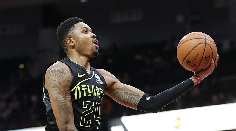 The Atlanta Hawks' Kent Bazemore goes to the basket past the Memphis Grizzlies' Dillon Brooks during the first half Tuesday, Feb. 6, 2018, at Philips Arena in Atlanta.