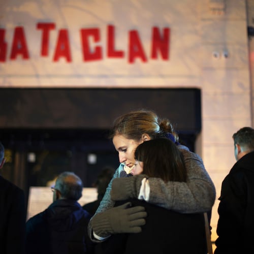 FILE - Women hug in front of the Bataclan concert hall in Paris on Nov. 13, 2016 . (AP Photo/Thibault Camus, File)