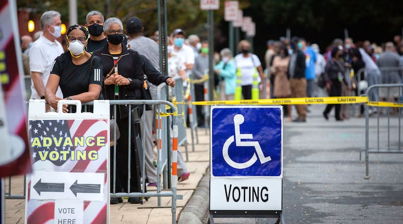 Long lines form outside the Cobb County Board of Elections and Registration offices for the first day of early voting Monday. STEVE SCHAEFER / SPECIAL TO THE AJC
